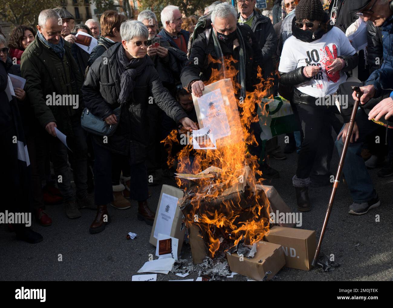 Demonstrators burn fake copies of the Spanish Constitution prior to the demonstration. Thousands of protesters demonstrate against the new law of 'aggravated public disorder', which replaces the law for the crime of sedition. The crime for which the pro-independence leaders were tried and convicted. Civil organisations consider that this new law harms civil rights, such as the right to organize, rally and demonstrate at mass events. This is the first major demonstration organised by civil organisations since September 11 in Barcelona. (Photo by Mario Coll/SOPA Images/Sipa USA) Stock Photo