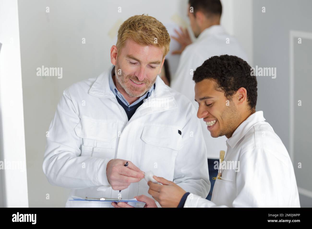 a house painter and an electrician laughing Stock Photo