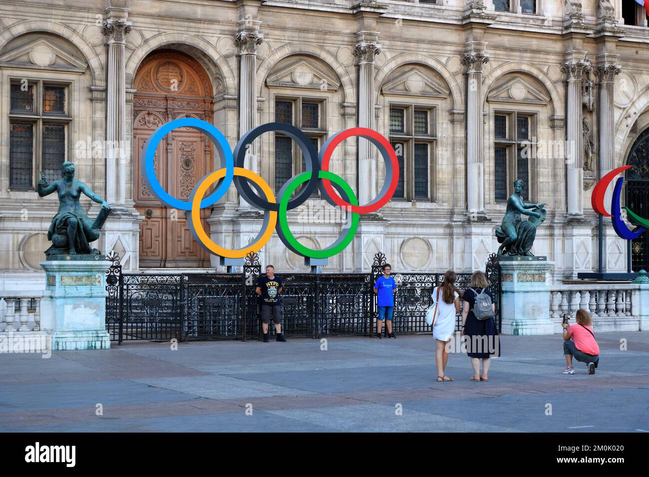 Tourists having their photos taken in front of the Olympic rings for 2024 Paris summer Olympic Games in front of Hotel de Ville (Paris city hall).Paris.France Stock Photo