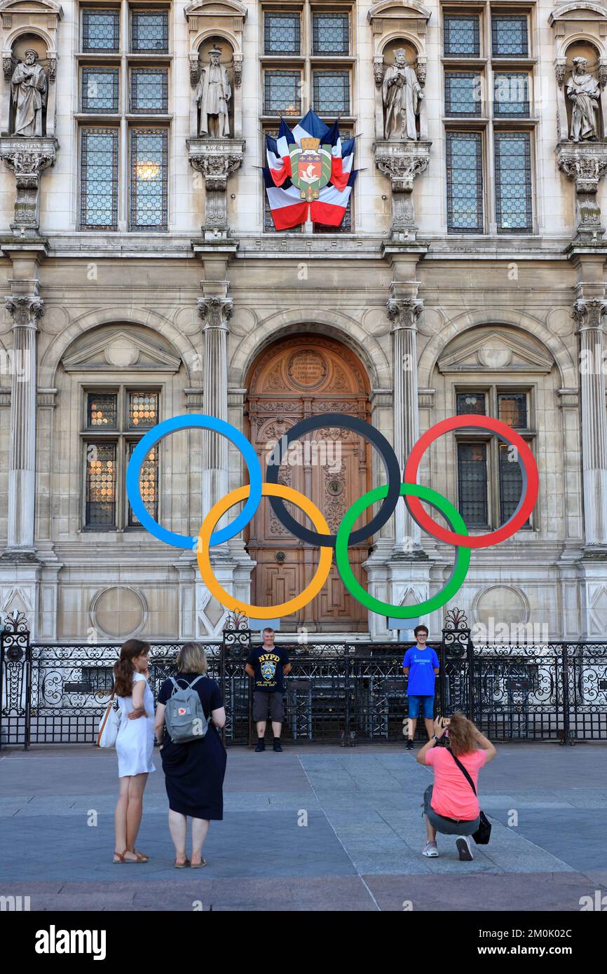 Tourists having their photos taken in front of the Olympic rings for 2024 Paris summer Olympic Games in front of Hotel de Ville (Paris city hall).Paris.France Stock Photo