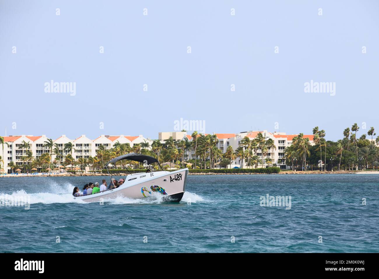 ORANJESTAD, ARUBA - MARCH 27, 2022: Water taxi taking guests to the private Renaissance island along Surfside beach in Oranjestad on Aruba Stock Photo