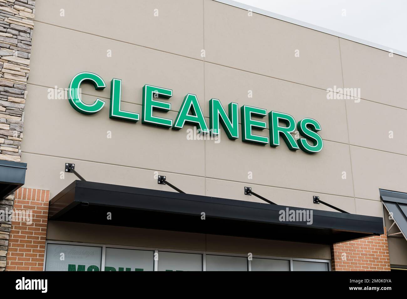 Large exterior business sign stating cleaners for a dry cleaners shop or business in a strip