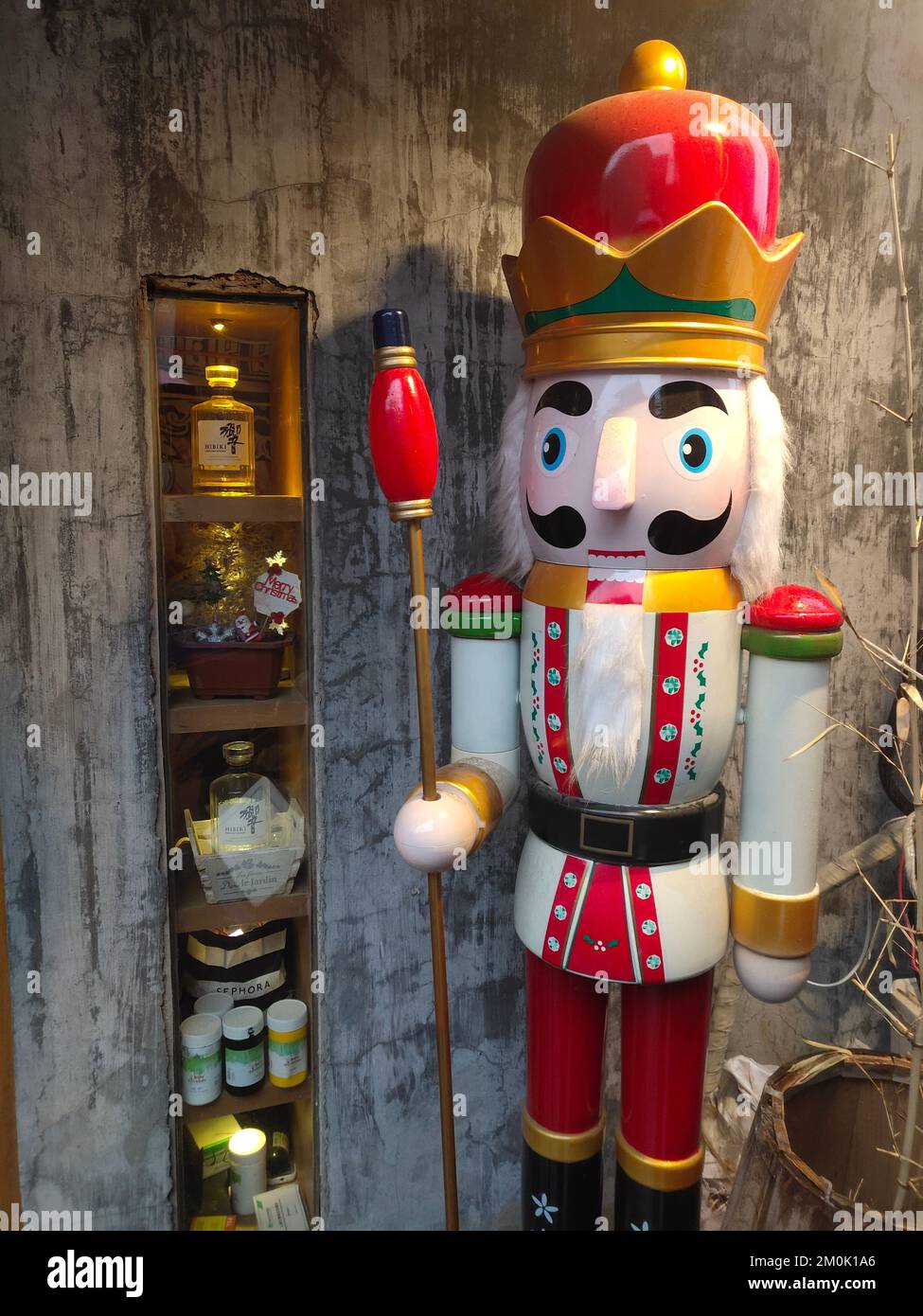 A nutcracker statue on the ride side of shelves with souvenirs on them