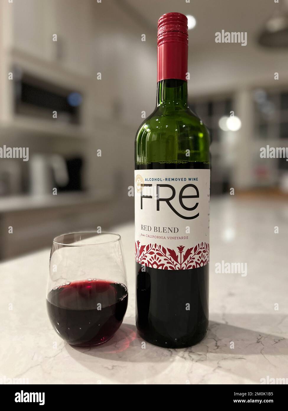 An open bottle and glass of Fre red blend alcohol removed wine Stock Photo