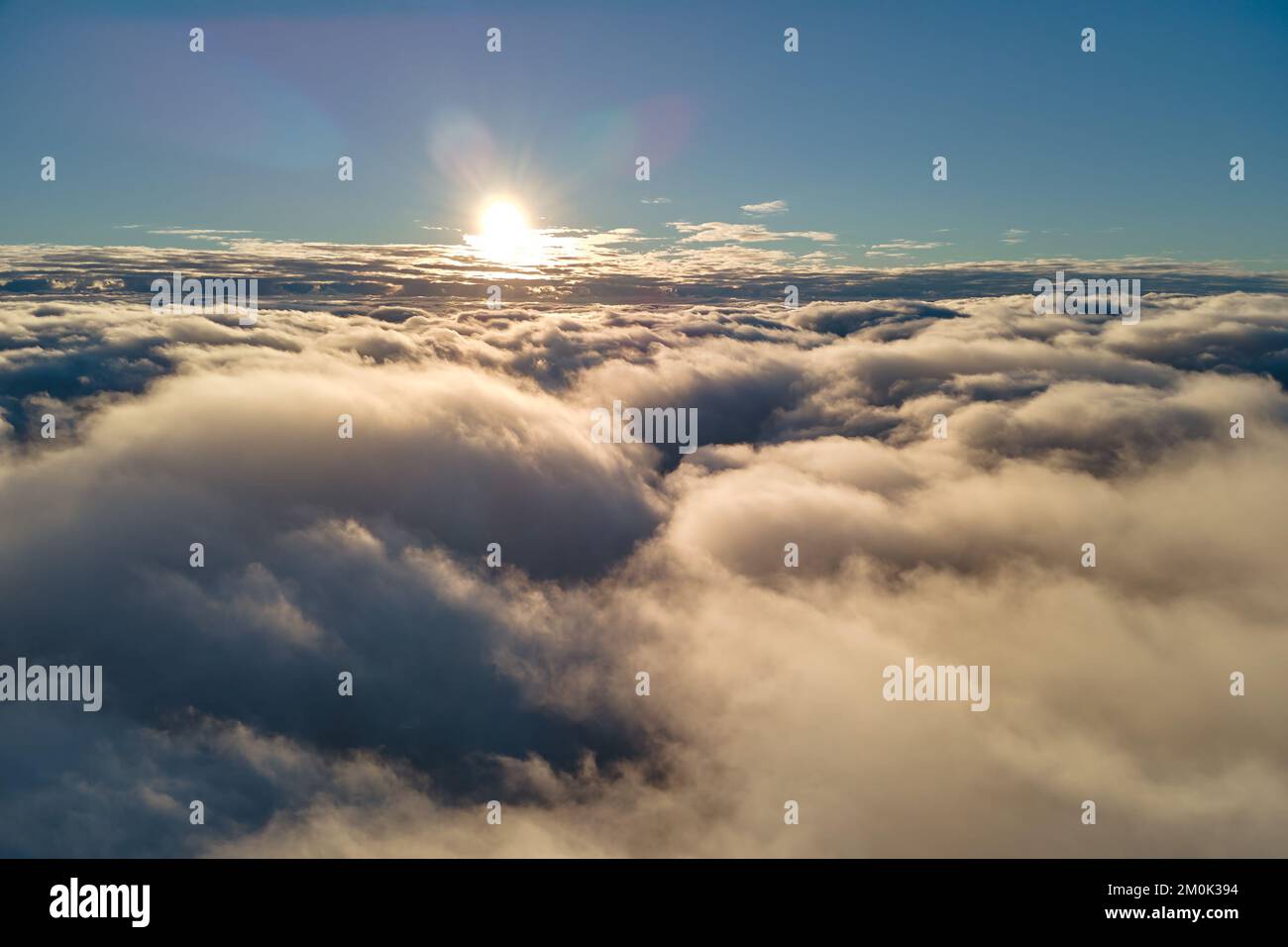 Aerial view from airplane window at high altitude of dense puffy ...