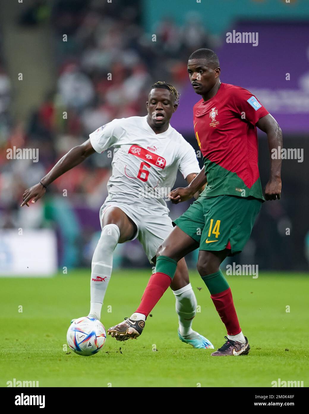 LUSAIL, QATAR - DECEMBER 6: Player of Portugal William Carvalho fights for the ball with player of Switzerland Denis Zakaria during the FIFA World Cup Qatar 2022 Round of 16 match between Portugal and Switzerland at Lusail Stadium on December 6, 2022 in Lusail, Qatar. (Photo by Florencia Tan Jun/PxImages) Stock Photo