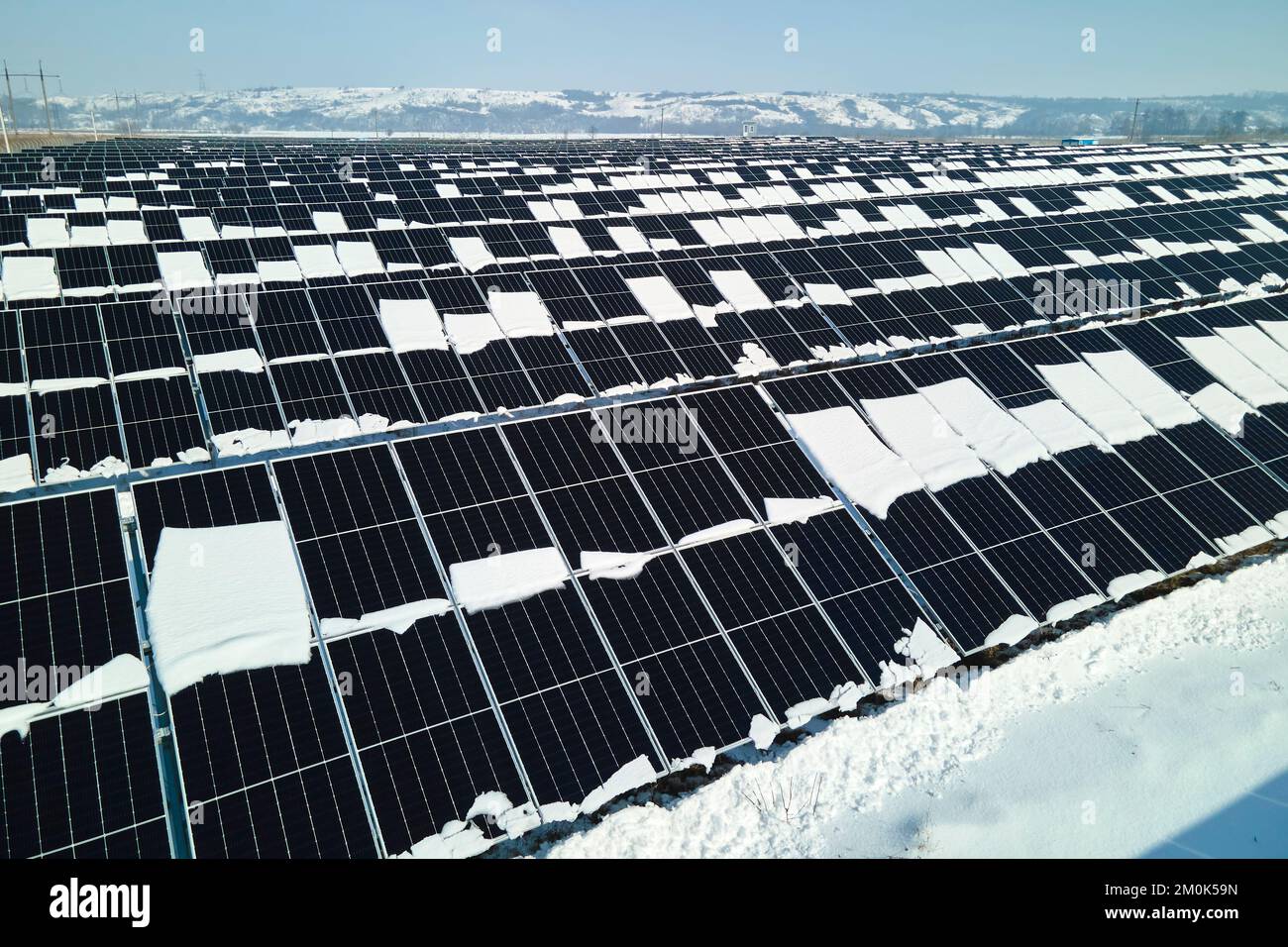 Aerial view of snow melting from covered solar photovoltaic panels at ...