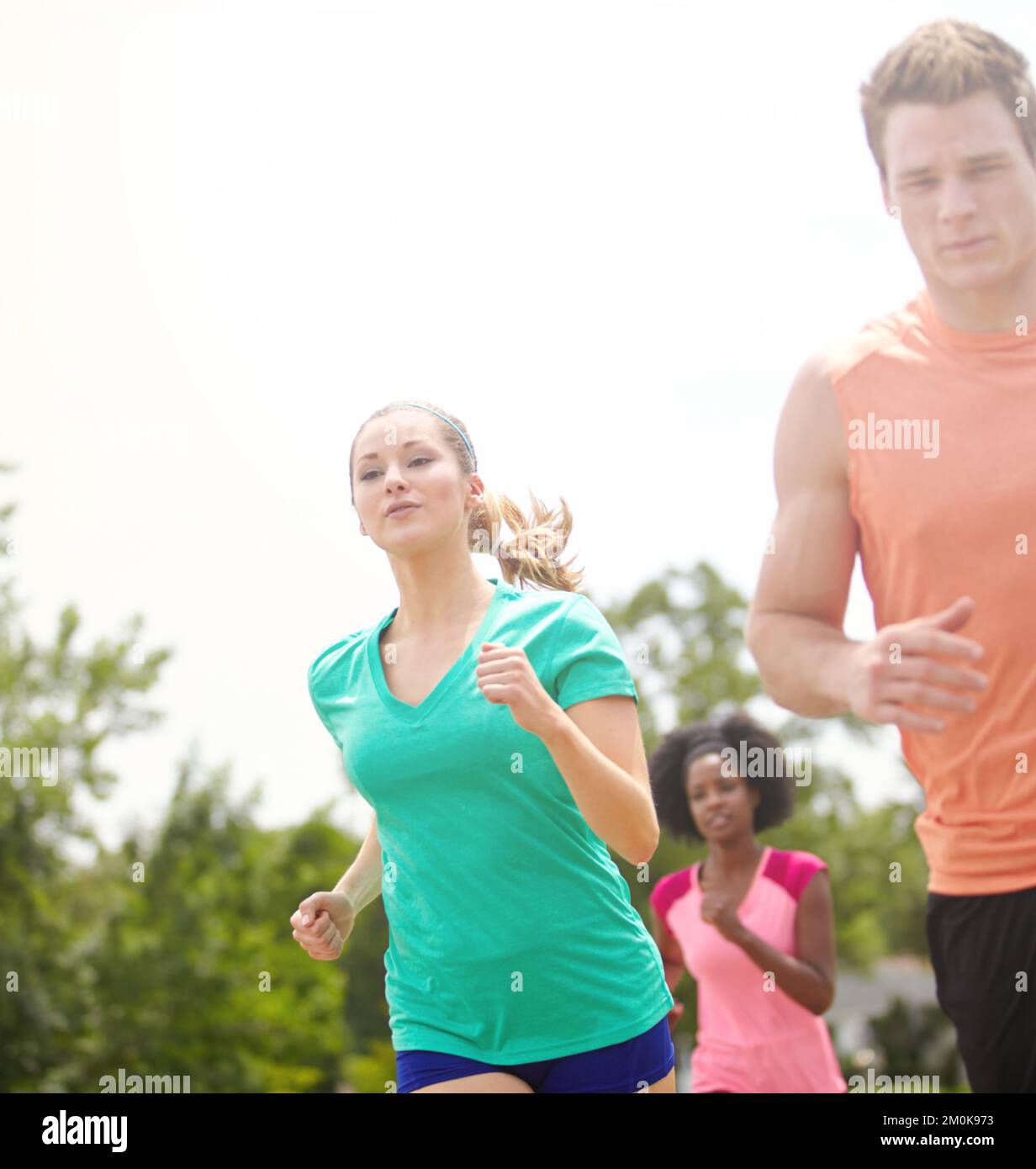 Challenging the women. a group of athletes running outdoors Stock Photo