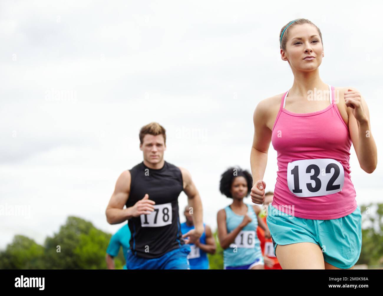 Its just her and the road. a driven female runner in first place Stock