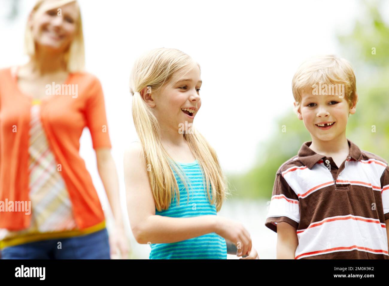 Out for a day with mom. Two cute young children spending time outdoors with their mother. Stock Photo