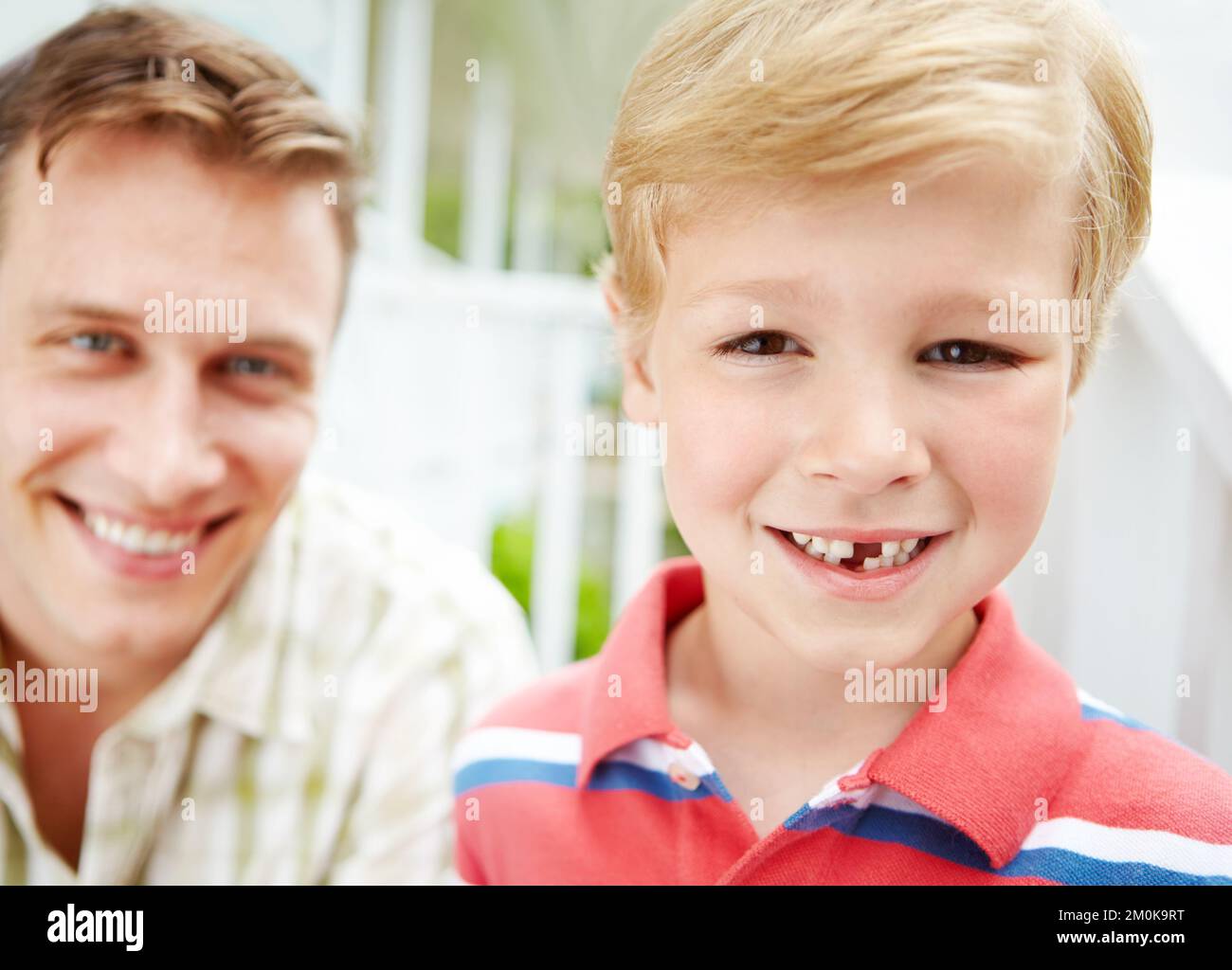 Dad said I was so brave when it fell out. A young boy with a missing tooth spending time with his father. Stock Photo