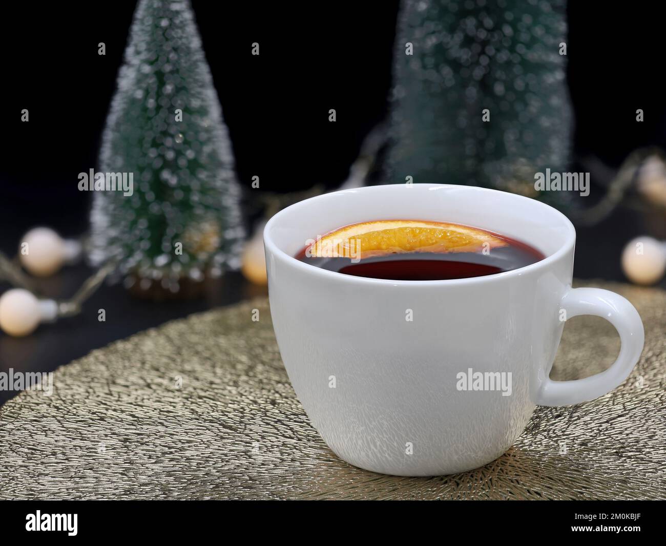 white cup of mulled wine with orange slice on christmas background Stock Photo