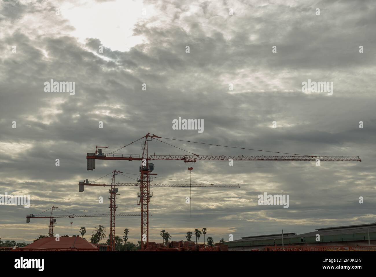 View of Tower cranes against the sky background in construction site at ...