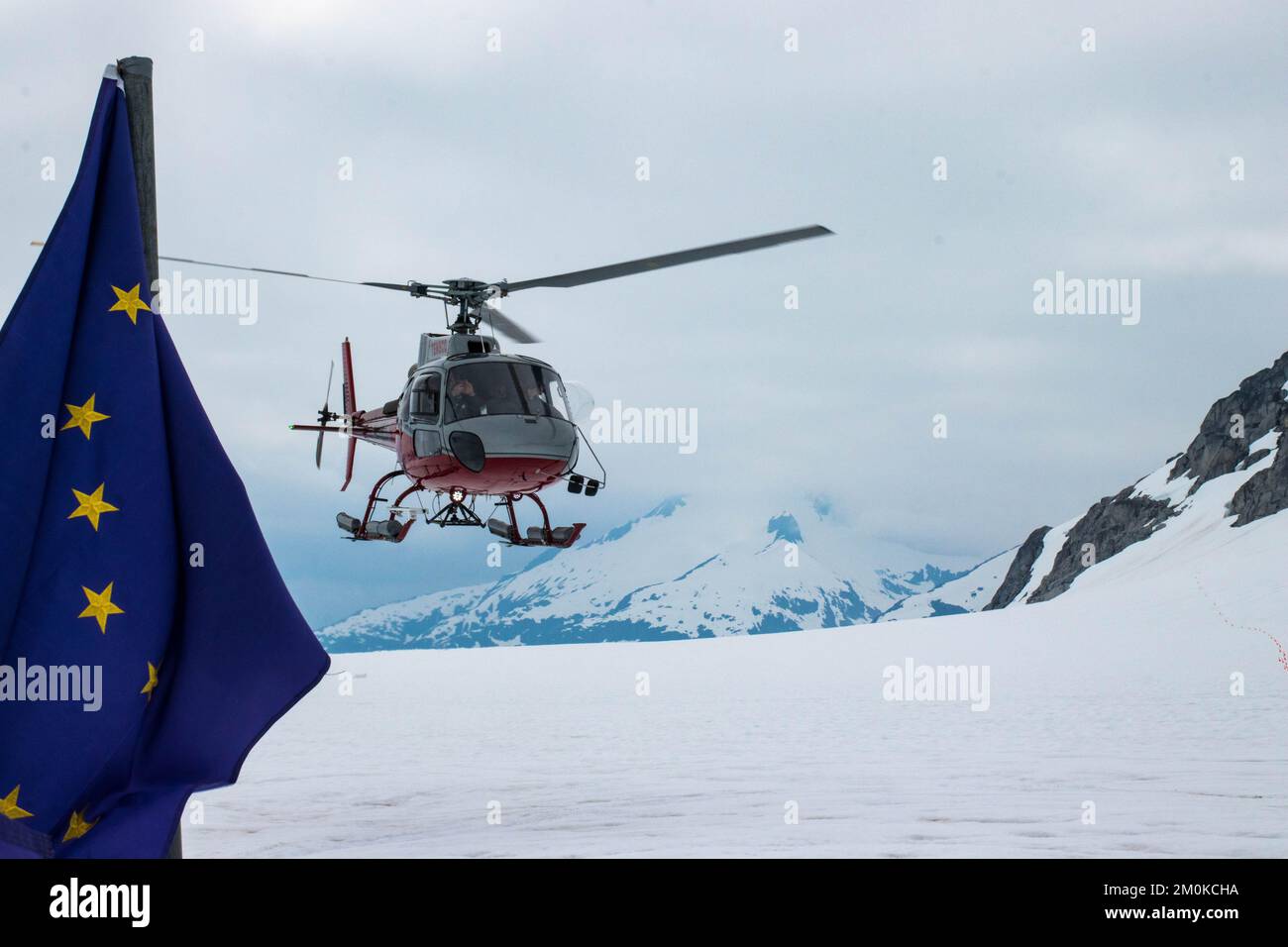 A Helicopter Landing on the Mendenhall Glacier in Alaska with the EU flag Stock Photo