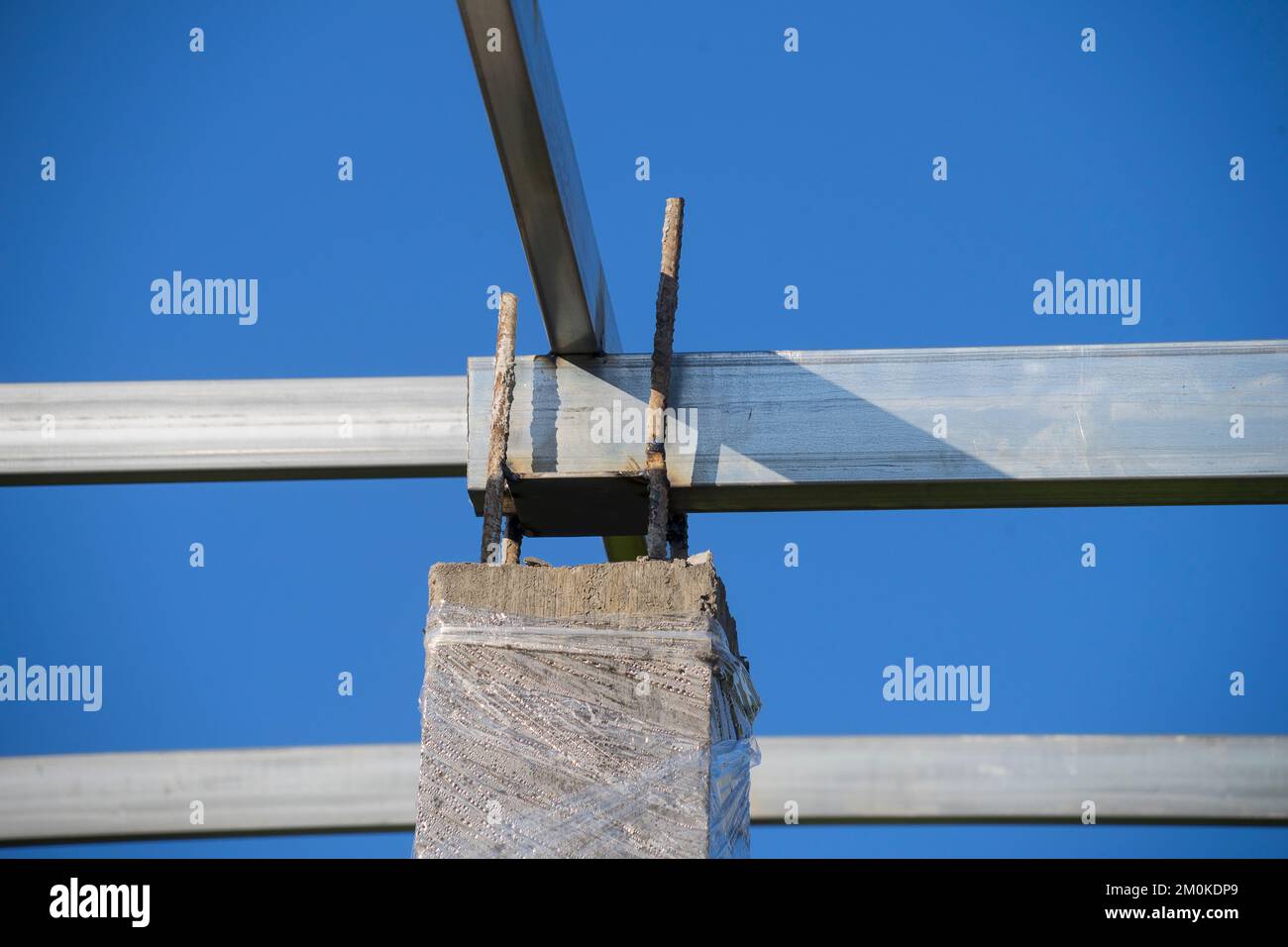 Unfinished concrete column under tower construction with protruded