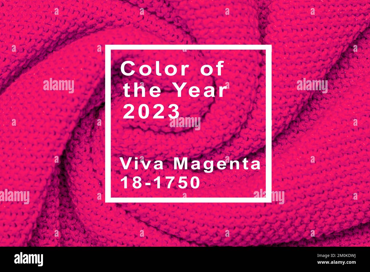 The texture of warm knitted sweater. Beautiful handmade knitted repeating pattern. Demonstrating Pantone color of the year 2023 viva magenta. Stock Photo
