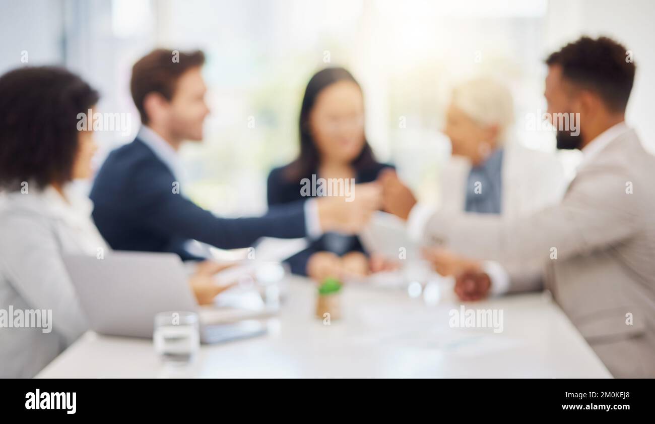 Defocused shot of a group of diverse businesspeople having a meeting in ...