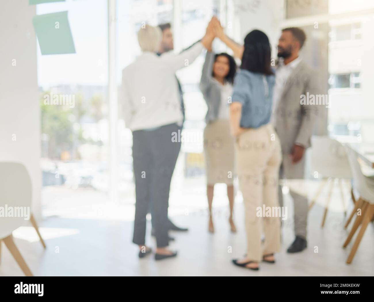 Defocused shot of diverse businesspeople giving each other a high five ...