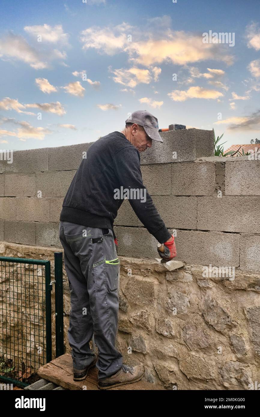 masons building new wall with white brick Stock Photo