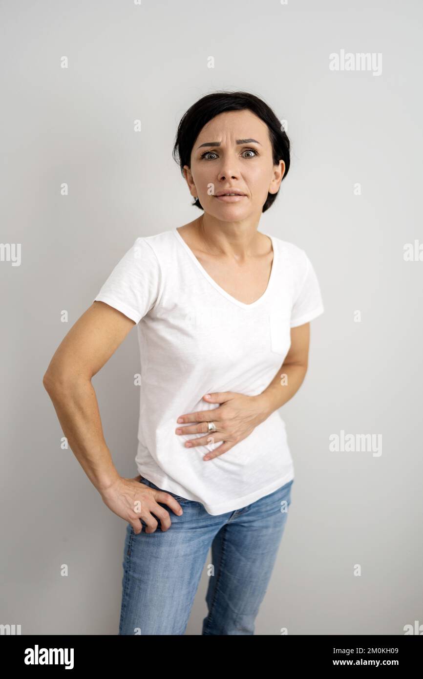 Middle Aged Woman Suffers From An Abdominal Pain Woman Holding Her Stomach In Pain Stock Photo