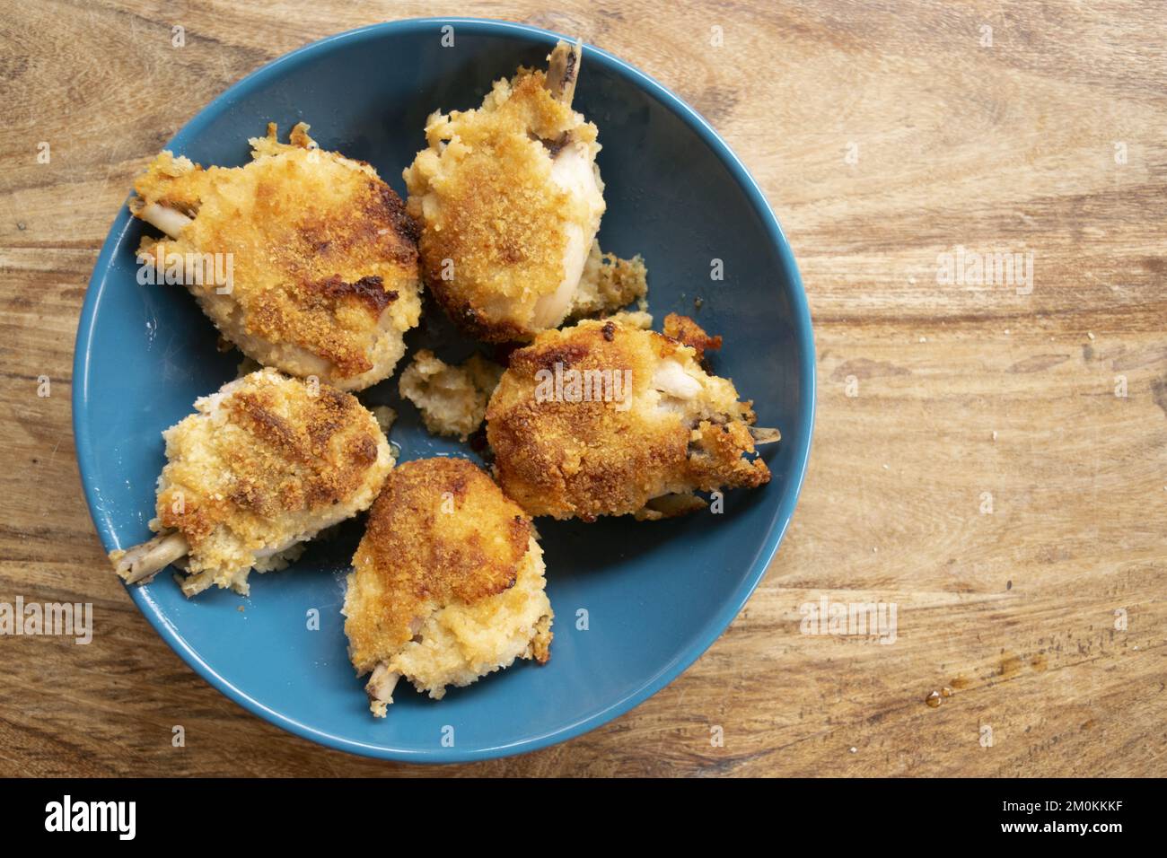 baked breaded chicken thighs called chicken lemon Stock Photo Alamy