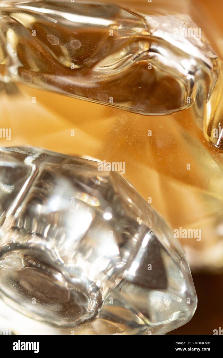 games of reflections of colors and lights through a glass bottle with perfumes Stock Photo