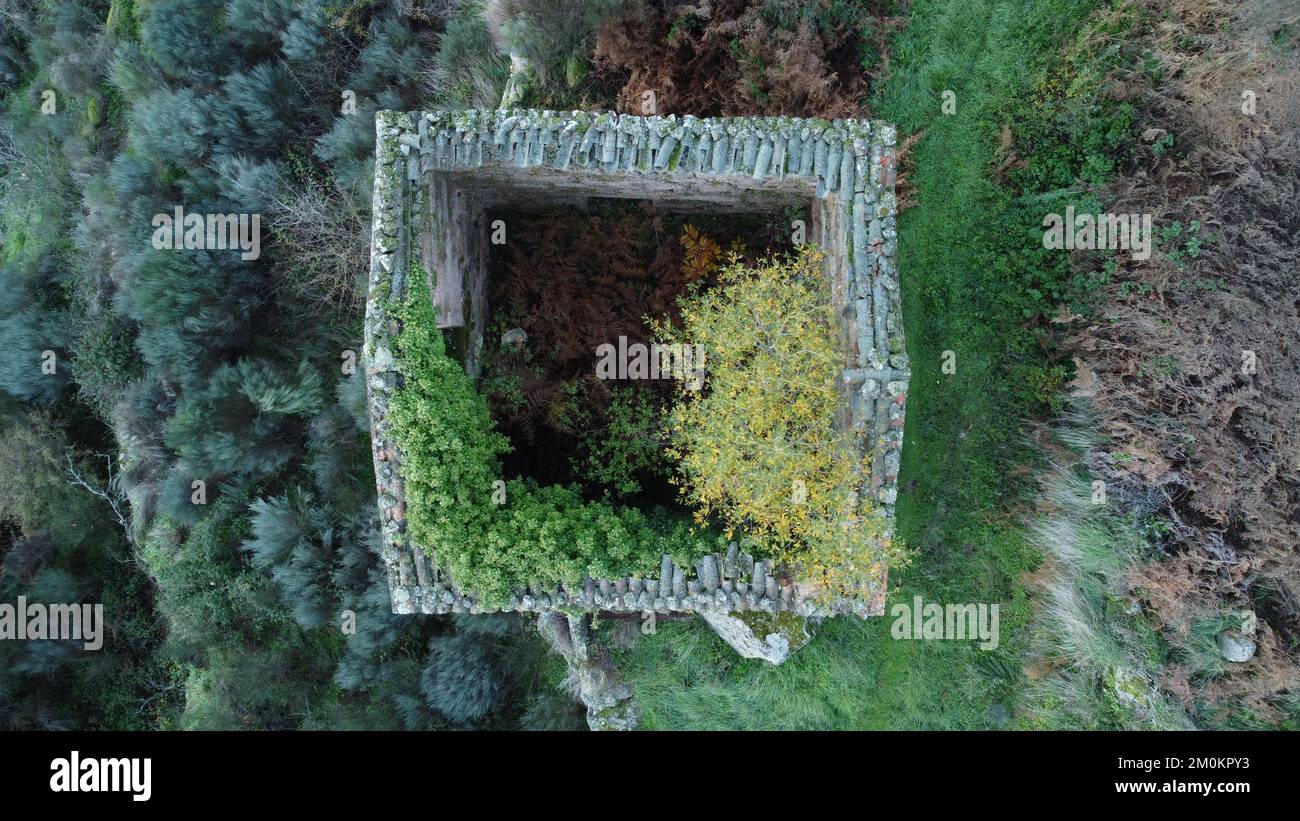 A top view of an incomplete square construction on a hill in autumn ...