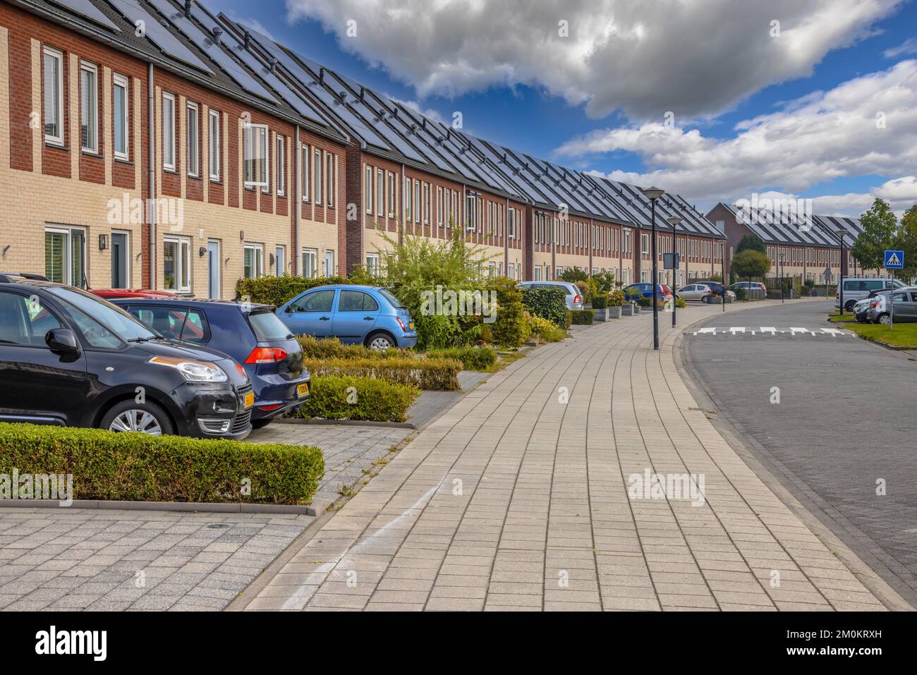 Row of modern houses in curved street. Contemporary neighborhood with