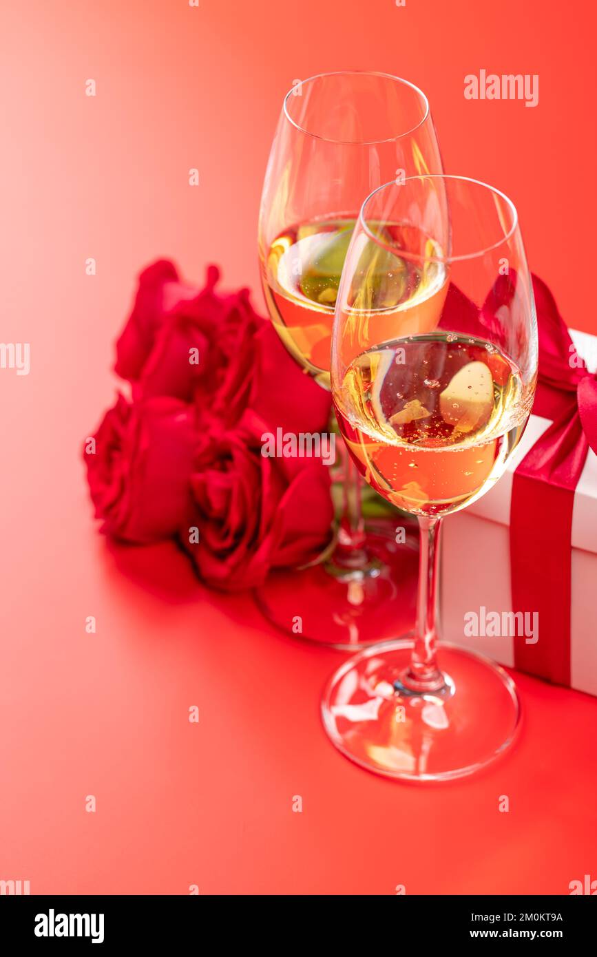 Valentines day card with champagne, rose flowers and gift box. On red ...