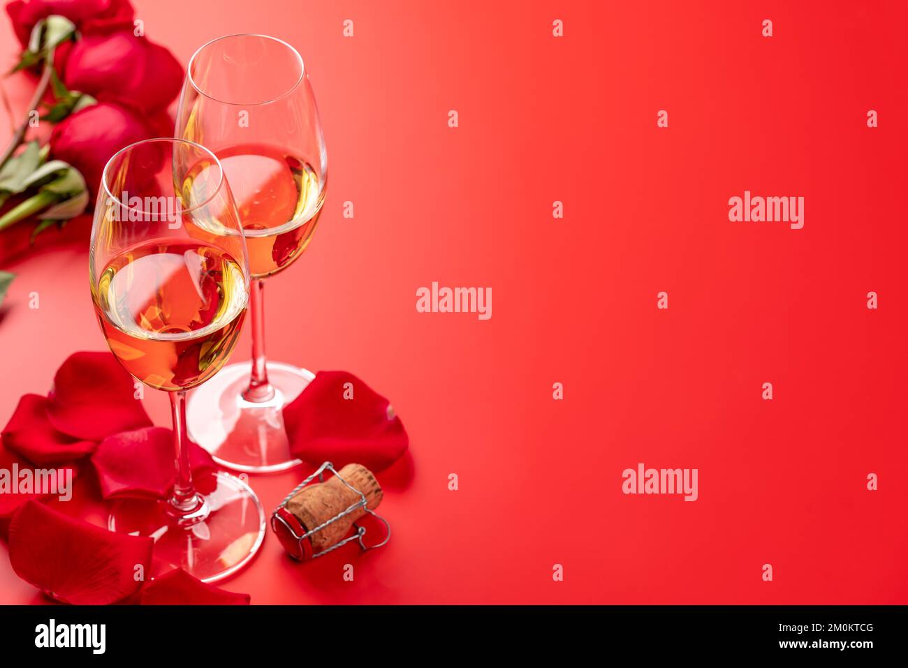 Valentines day card with champagne and rose flowers. On red background ...