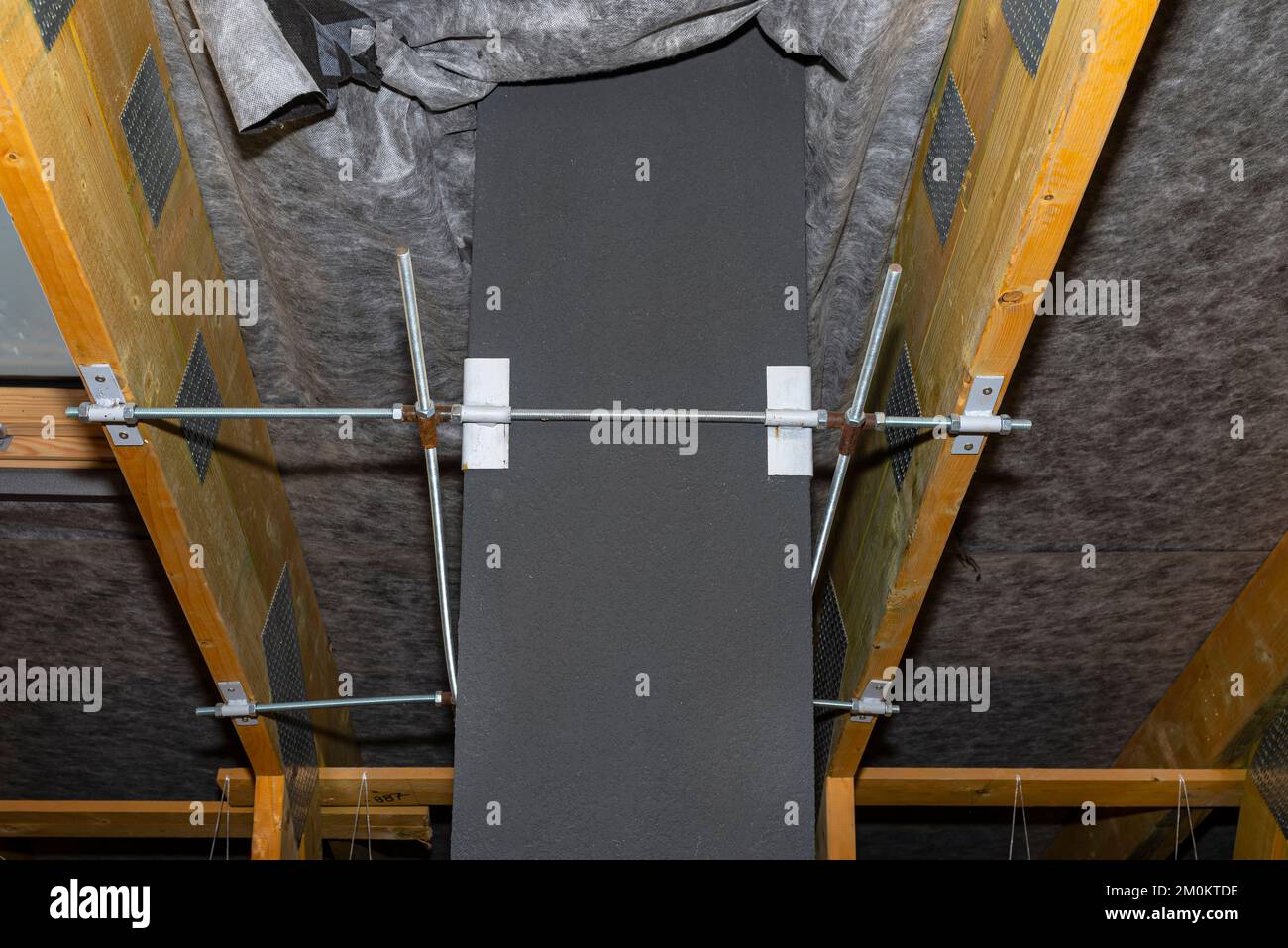 Steel fixing of the ceramic chimney to the trusses inside the attic ...