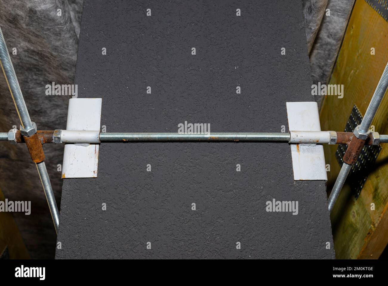 Steel fixing of the ceramic chimney to the trusses inside the attic. Stock Photo