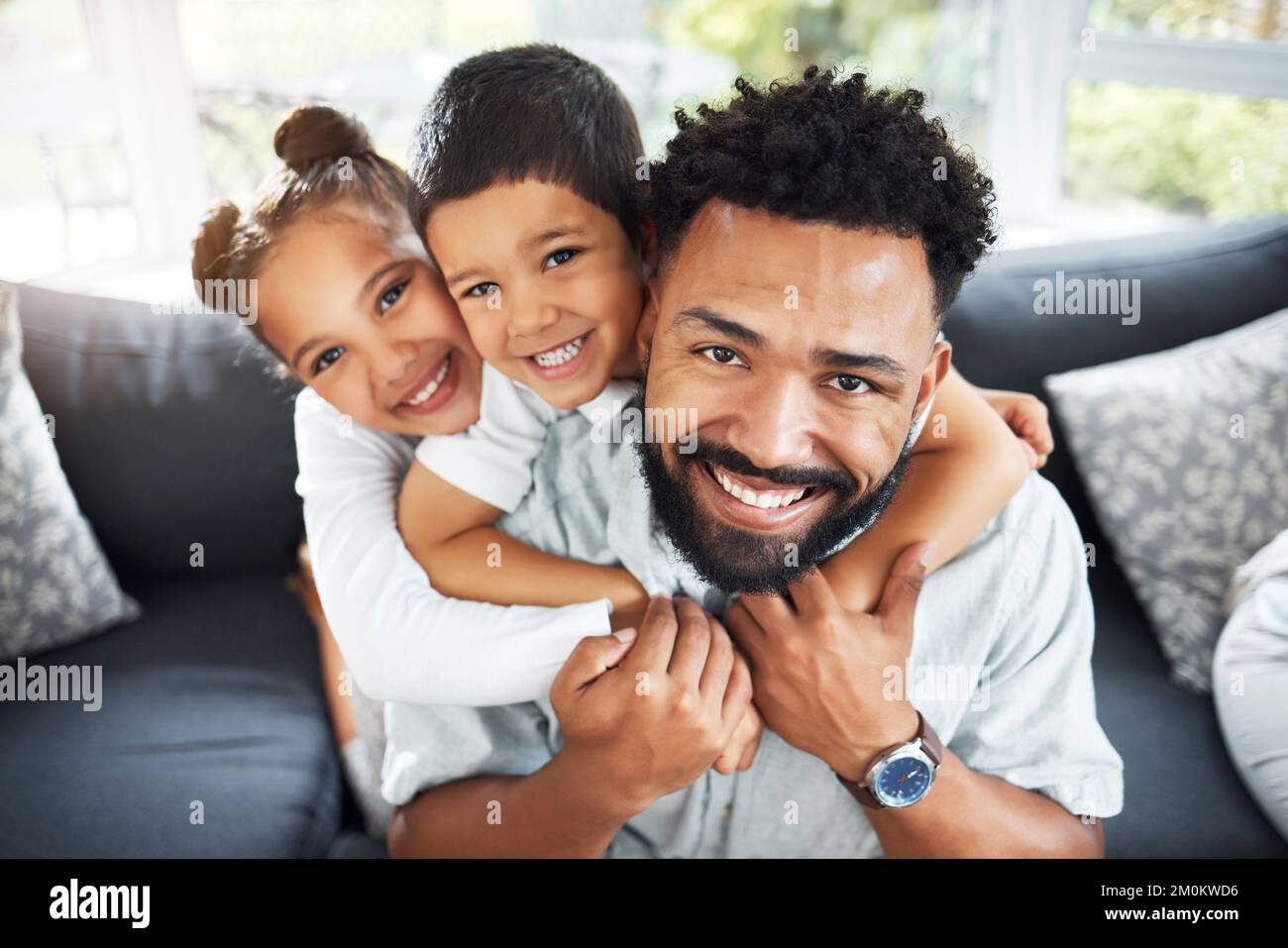 Happy young mixed race dad bonding with his adorable children in a ...