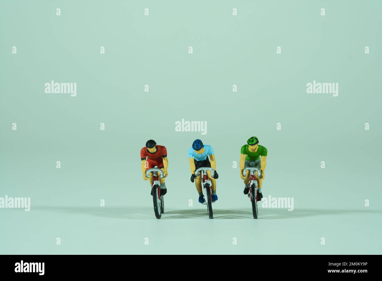 Racing cyclist isolated on light background, front view Stock Photo - Alamy