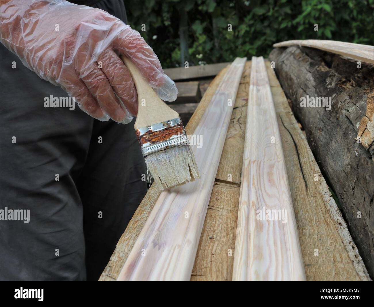 painting the floor wooden skirting boards in a street with an