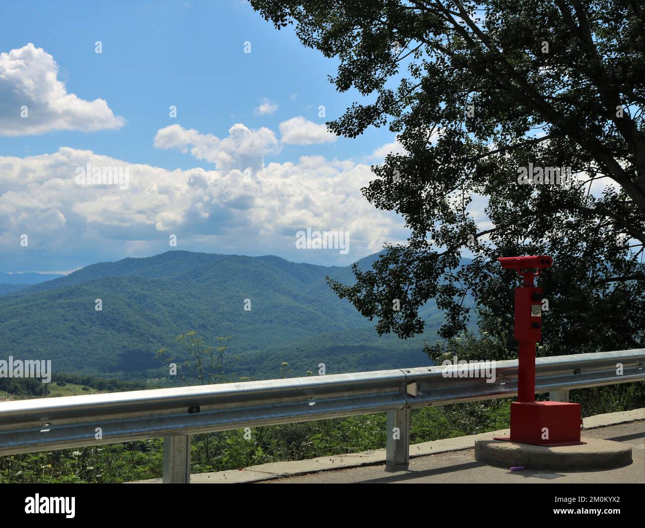 observation deck in the mountains with red coin-operated binoculars for ...
