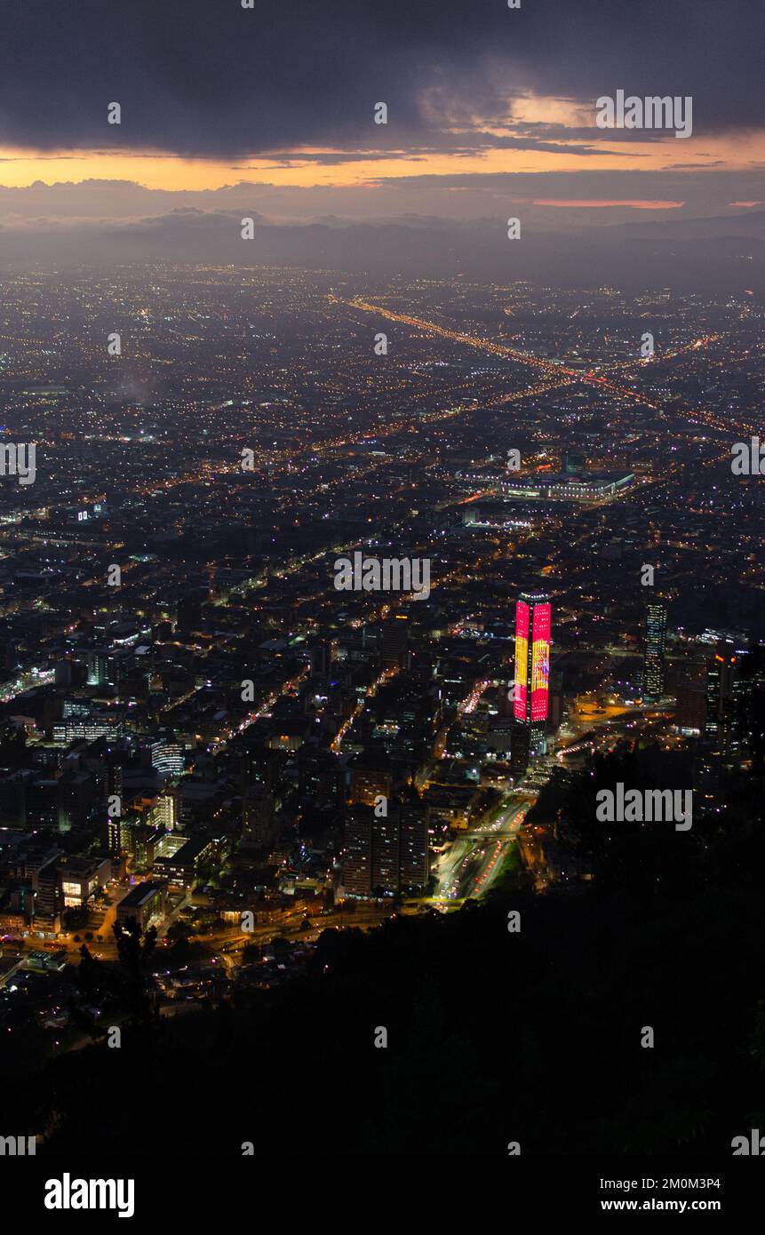 An aerial view of an illuminated cityscape with modern buildings at ...