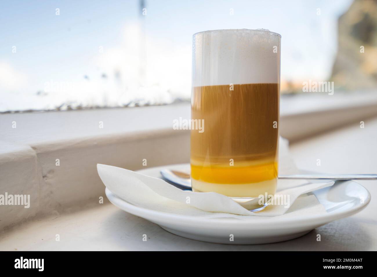 Three layers coffee, milk and liqueur makes delicious barraquito