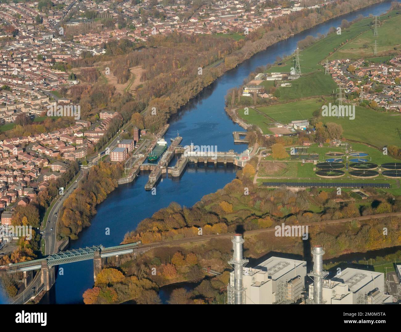 An aerial view of a lock on the Manchester Ship Canal, with a ship going down stream, at Irlam. West of Manchester. north west England, UK Stock Photo