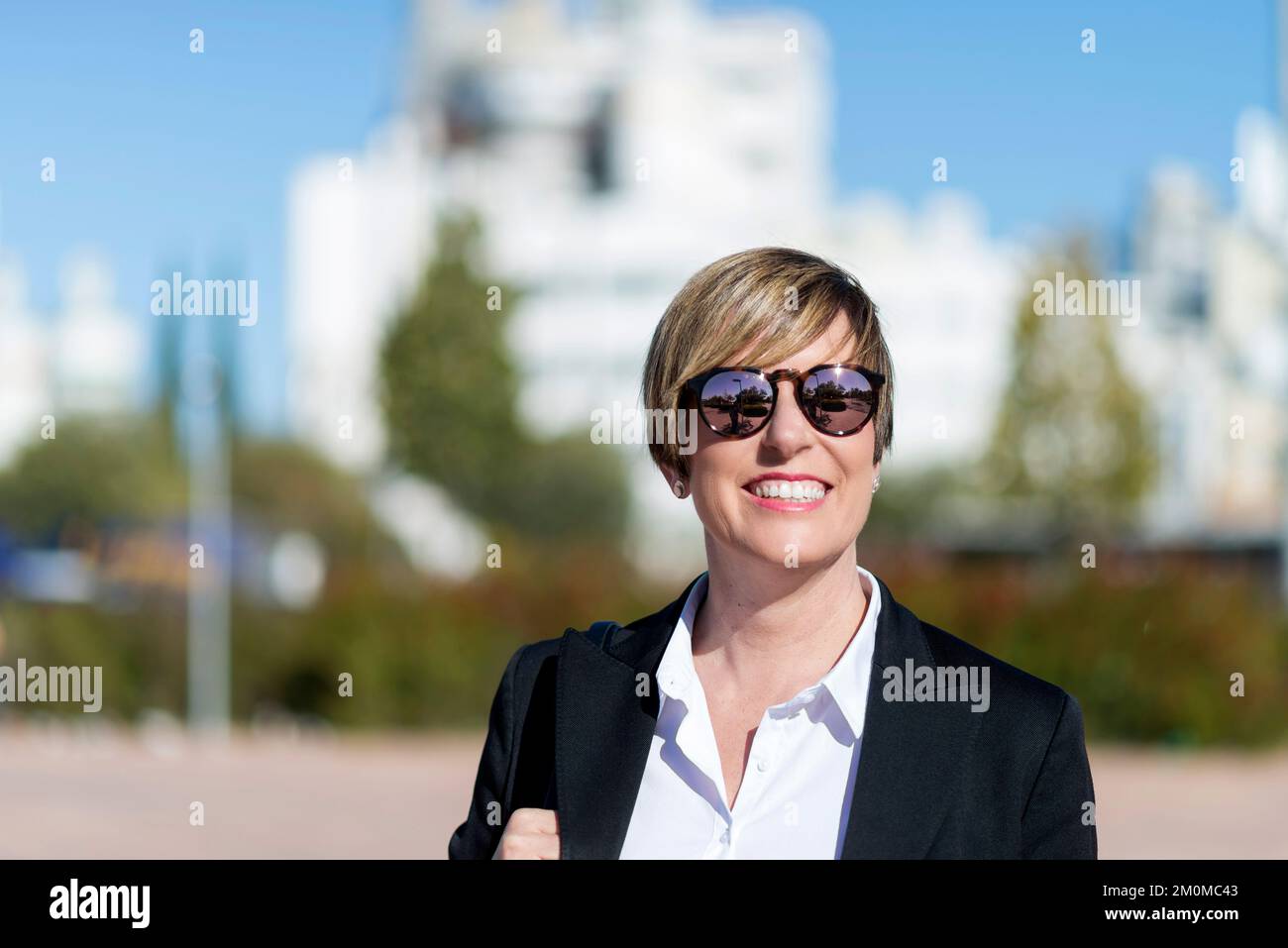 Half length portrait of confident proud ceo expert dressed in elegant apparel looking at camera while standing on street Stock Photo