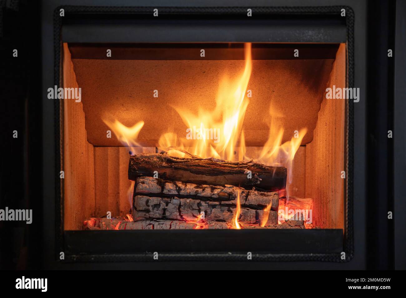 Fire flames and burning wood logs, energy stove fireplace close up