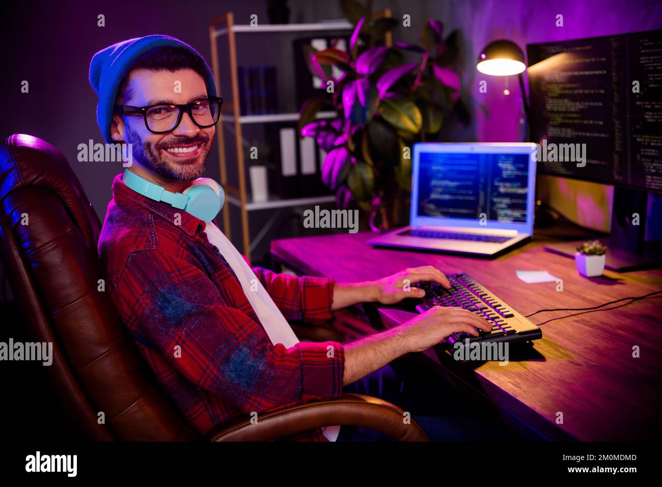 Photo of happy smiling programmer wear spectacles hat creating software ...