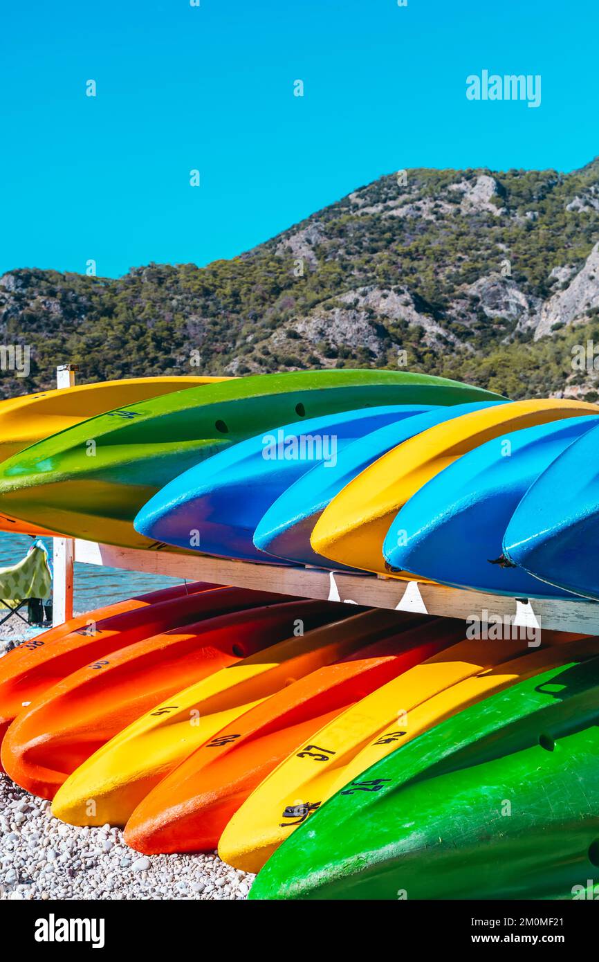 Colored kayak canoes on the sea beach. Summer holidays and activities on the water. Vacation, relax, sport concept. High quality photo Stock Photo