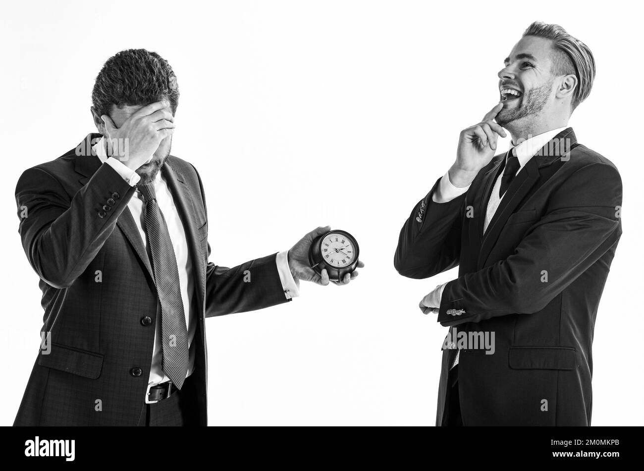 Businessmen misunderstanding about timing. Men in classic suits Stock Photo