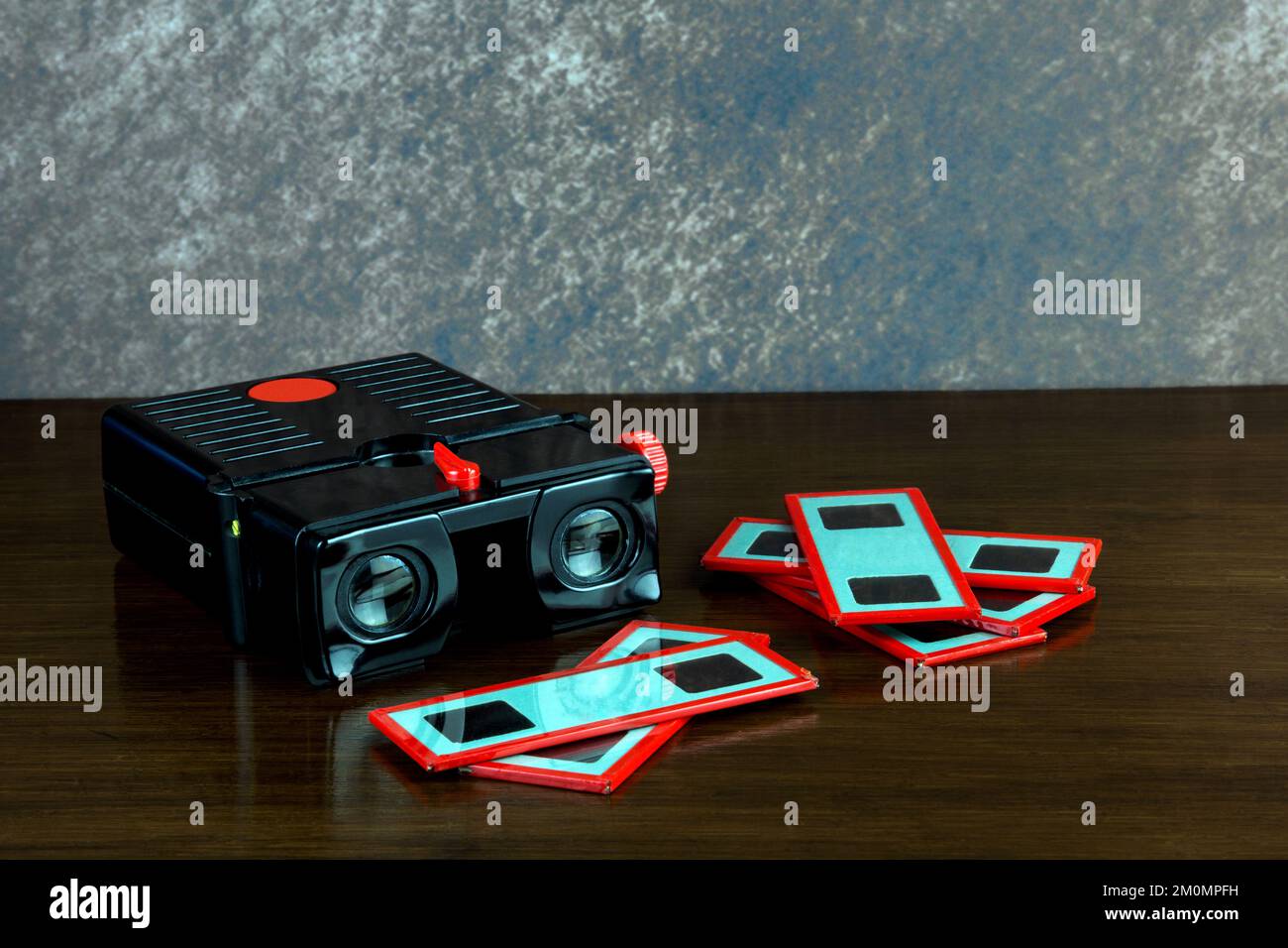 Old stereo slide viewer with glass stereo slides on a varnished wooden