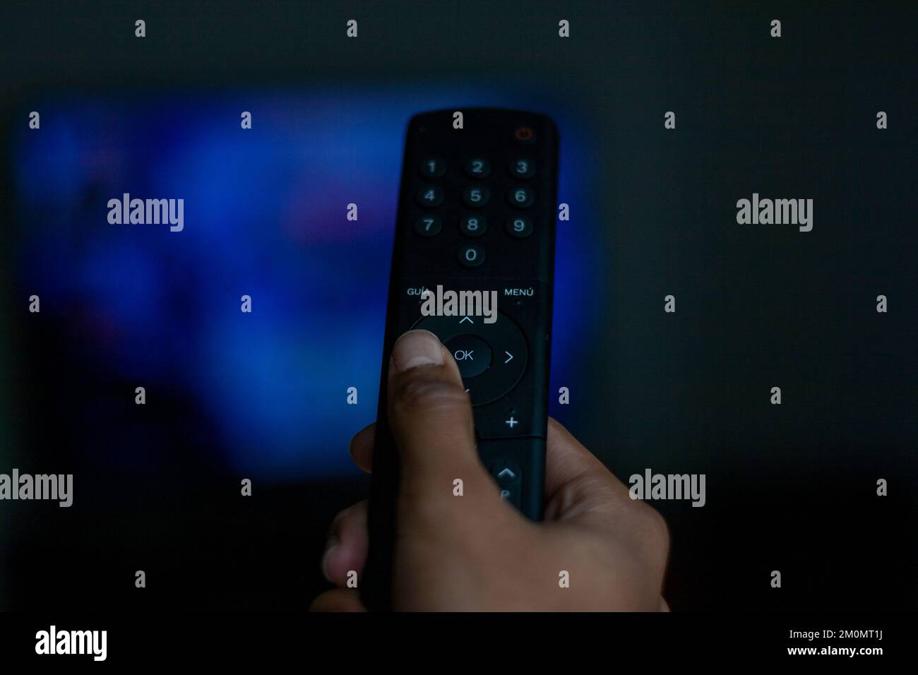 hand directing a television remote where you can see the different