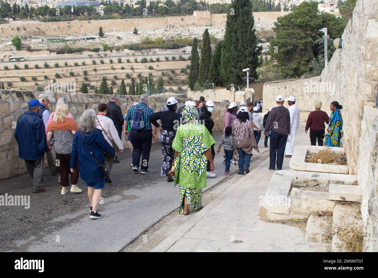 9 Nov 2022 Visitors walking down the steep hill from the Church of Mary Magdalene toward the Garden of Gethsemene on the western slopes of the City of Stock Photo