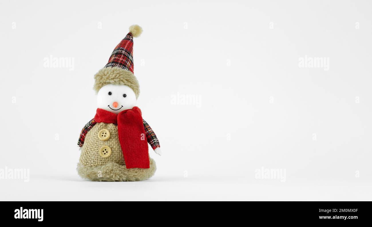 Handmade funny snowman with a fabric suit on white background Stock Photo