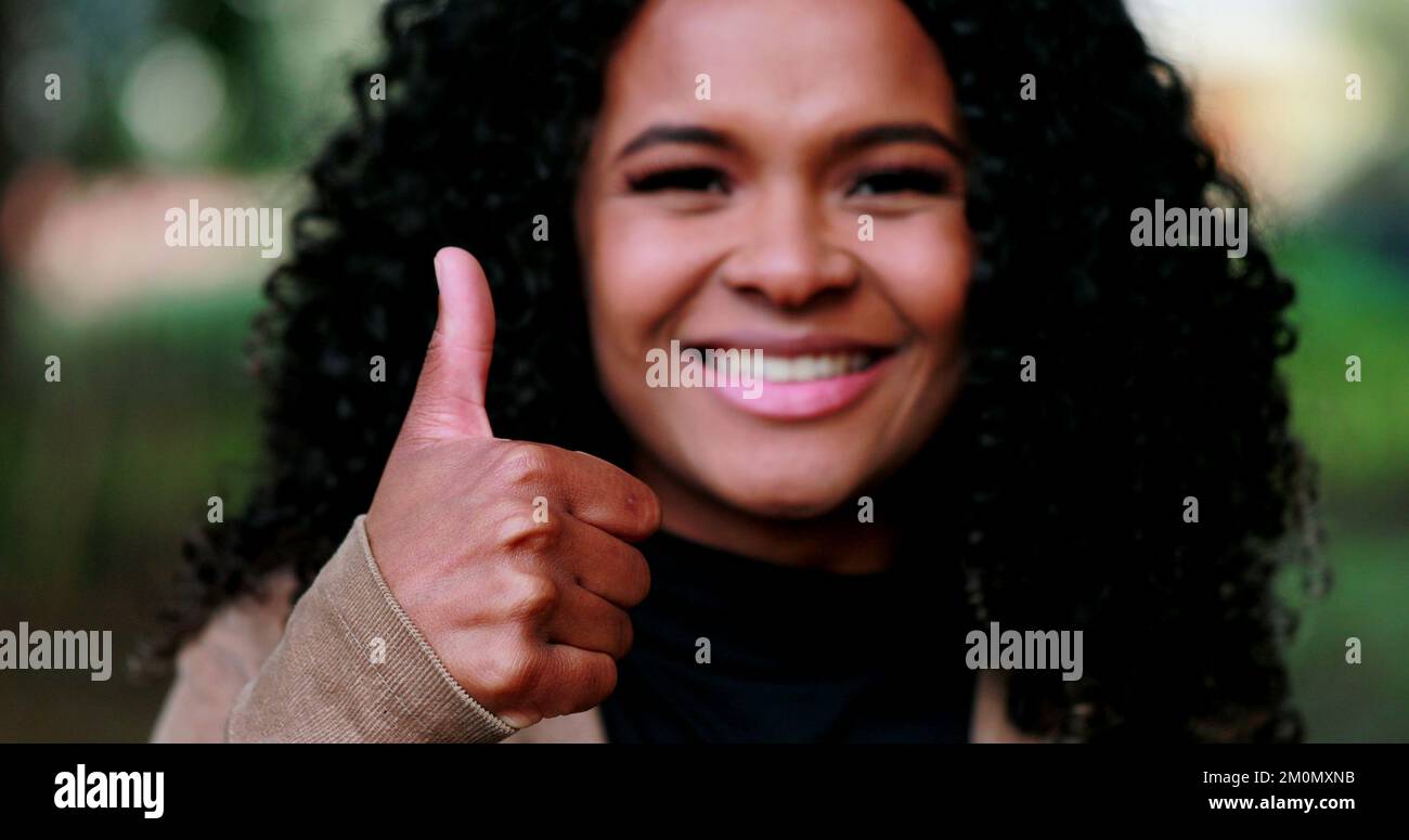 Positive Black woman giving approval with thumb up Stock Photo - Alamy
