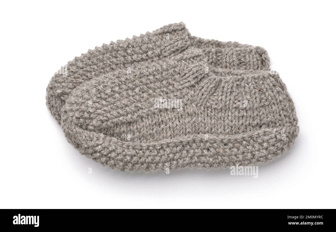 Side view of gray hand knitted wool slipper socks isolated on white Stock Photo